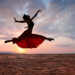 Woman leaping for joy at sunset 130117 shutterstock_22075510 (2)